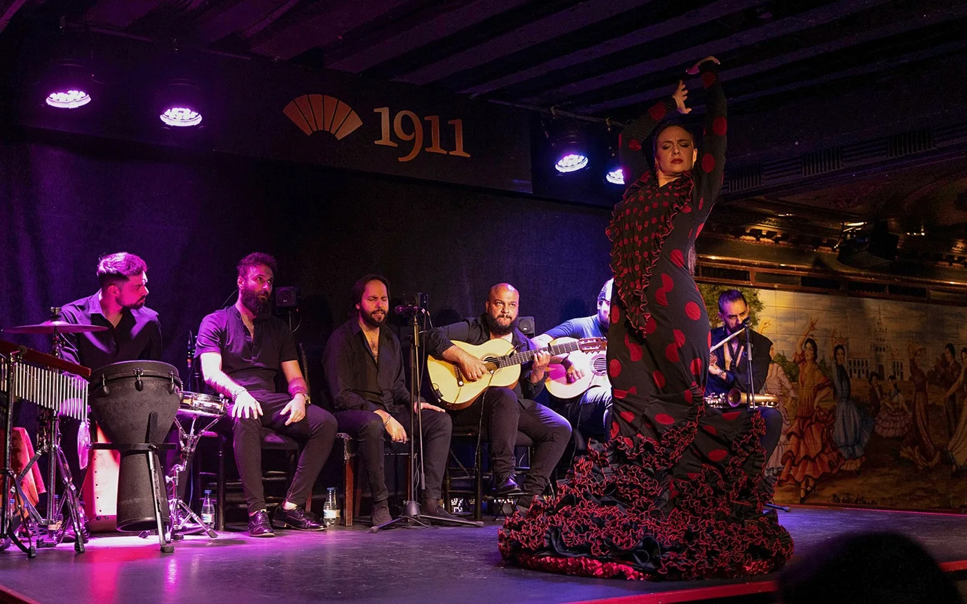 A dancer and musicians on the Tablao Flamenco 1911 stage